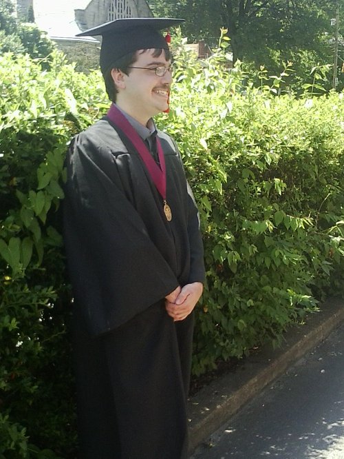 David in his robes, with honors medallion, before diploma ceremony